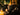 Candle labeled 'One More Chapter' with decorative elements on a dark background