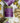 Three 'ROMANTASY' candles with purple labels on a textured surface.